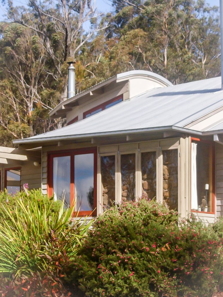 Sustainable home with curved and layered roof